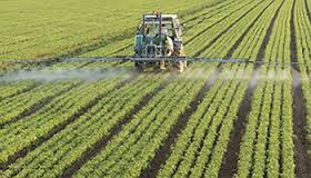 A farmer spraying a field